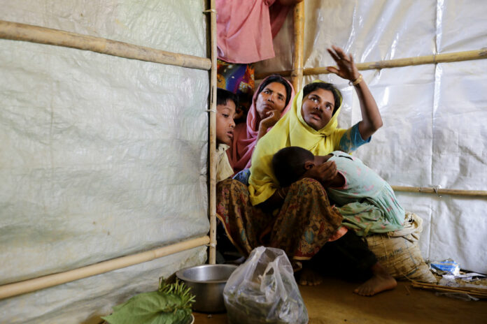 In this June 28, 2018, photo, Mustawkima, sits in her relative's shelter as she talks about abandoning her previous shelters destroyed by heavy rains in Balukhali refugee camp, Bangladesh. Photo: Wong Maye-E / Associated Press