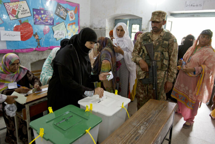 A woman casts her vote Wednesday at a polling station for the parliamentary elections in Rawalpindi, Pakistan. Photo: B.K. Bangash / Associated Press