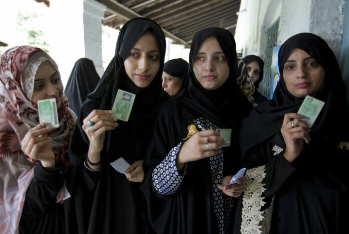 Pakistani women voters pose with their identity cards waiting to cast their vote Wednesday in Rawalpindi, Pakistan. Photo: B.K. Bangash / Associated Press