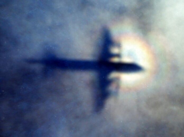 FILE - In this March 31, 2014 file photo, the shadow of a Royal New Zealand Air Force P3 Orion is seen on low level cloud while the aircraft searches for missing Malaysia Airlines Flight MH370 in the southern Indian Ocean, near the coast of Western Australia. Photo / Rob Griffith / Associated Press
