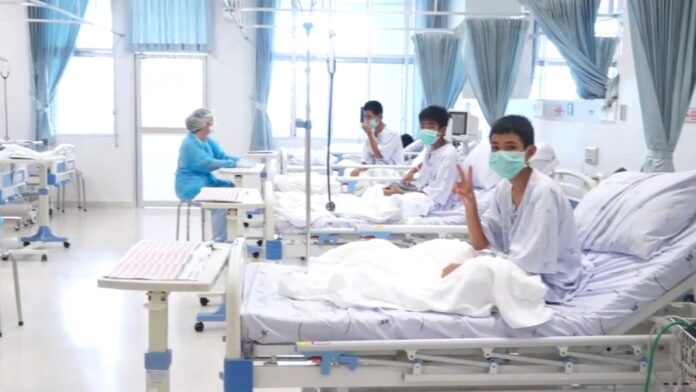 A screenshot shows the rescued boys in quarantine Wednesday inside Chiangrai Prachanukroh Hospital.