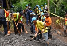 Outside the Cave, Meet Those Giving All For Strangers Volunteers help public workers put sand and dry soil Sunday on top of the muddy road leading to Luang Khun Nam Nang Non cave in Chiang Rai province.