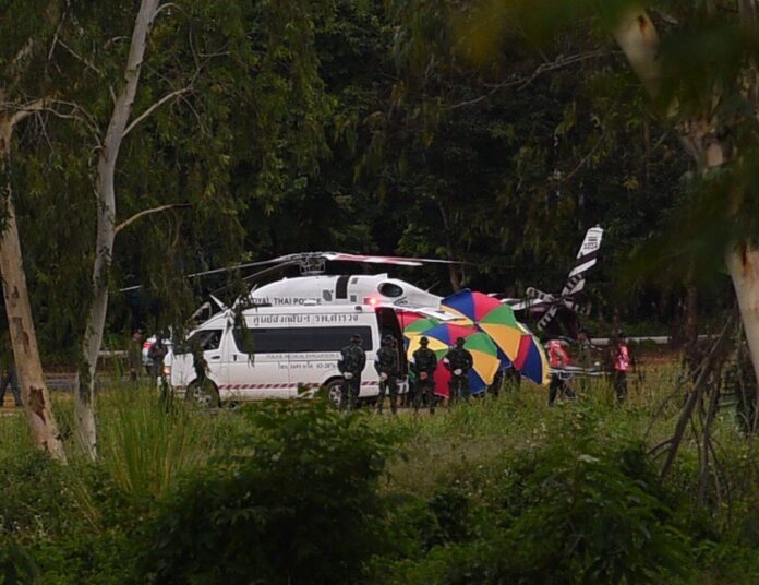 One of the rescued boys is brought to a helicopter on Tuesday.