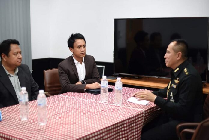 Titipol Phakdeewanich, center, sits with Col. Mongkut Kaewprom, right, on Thursday in Ubon Ratchathani province. Photo: Titipol Phakdeewanich / Facebook