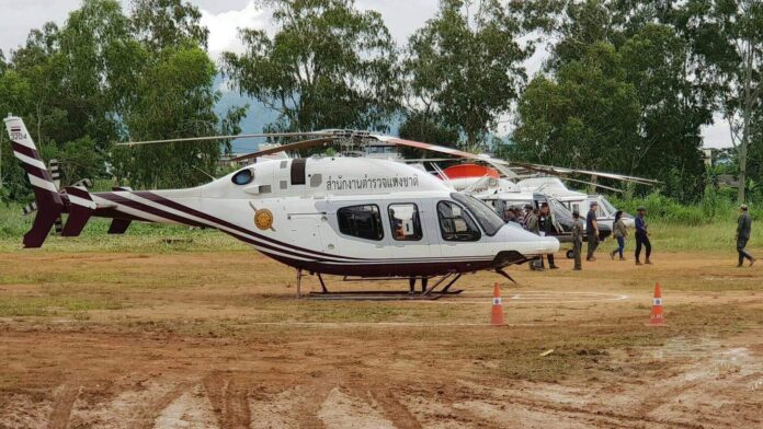 Rescue helicopters stand ready about a 5-kilometer drive from the entrance to the Luang cave complex in Chiang Rai province. Rescue helicopters stand ready about a 5-kilometer drive from the entrance to the Luang cave complex in Chiang Rai province.