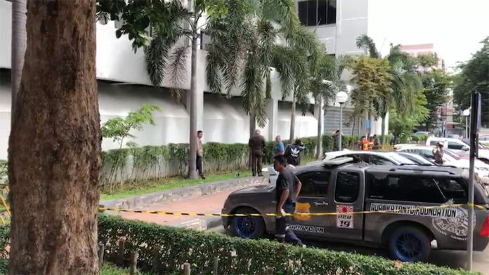 Police and rescuers at the scene outside the Court of Justice Monday where a man jumped to his death after the lead suspect in his son's murder case was acquitted.
