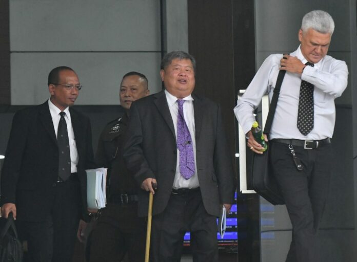 Premchai Karnasuta leaves the Criminal Court on Monday.