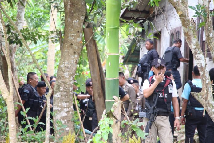 Police inspect the scene Thursday.
