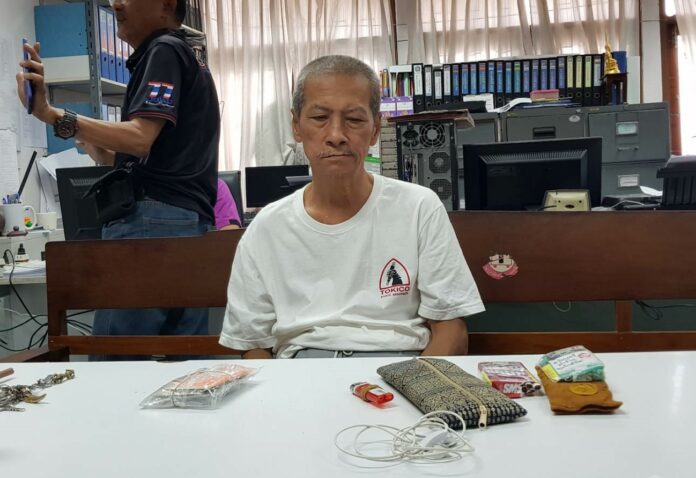 Suppachai Boonlakka, who has been expelled from the monkhood after allegedly assaulting a novice, appears Sunday at a local police station in Kanchanaburi province.