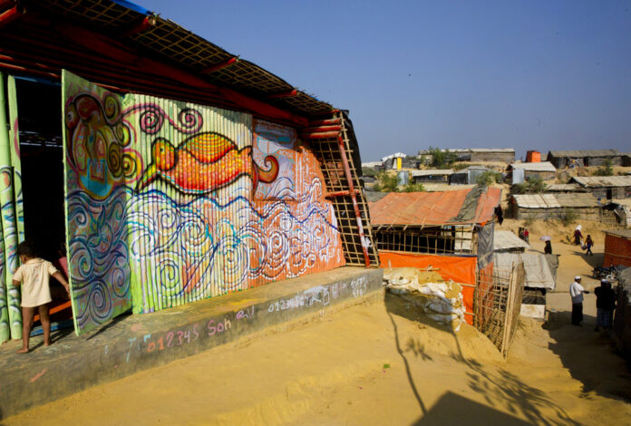A life size mural is seen Jan. 21, 2018, on the wall of a makeshift school for Rohingya refugee children at Kutupalong Refugee Camp near Cox's bazar, Bangladesh. The mural is created by a public art organization called Artolution, who collaborate with refugees to create large pieces of art and use art as therapy in conflict zones around the world. Photo: Manish Swarup/ Associated Press