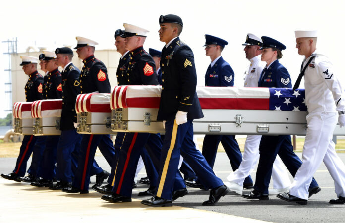 Military members carry transfer cases from a C-17 at a Wednesday ceremony marking the arrival of the remains believed to be of American service members who fell in the Korean War at Joint Base Pearl Harbor-Hickam in Hawaii. Photo: Susan Walsh / Associated Press Military members carry transfer cases from a C-17 at a Wednesday ceremony marking the arrival of the remains believed to be of American service members who fell in the Korean War at Joint Base Pearl Harbor-Hickam in Hawaii. Photo: Susan Walsh / Associated Press