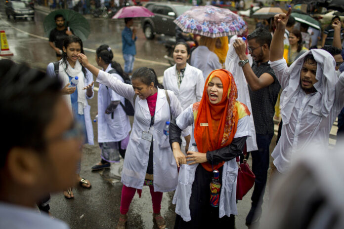 Bangladeshi students shout slogans as they block a road Thursday during a protest in Dhaka, Bangladesh. Photo: A. M. Ahad / Associated Press