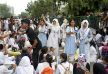 Student Protests Surge in Bangladesh Capital Bangladeshi students shout slogans and block a road Saturday during a protest in Dhaka, Bangladesh. Photo: A. M. Ahad / Associated Press
