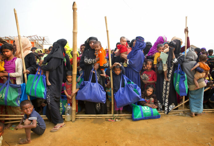Rohingya Muslim women with their children stand in a queue outside a food distribution center in January at Balukhali refugee camp 50 kilometers (32 miles) from, Cox's Bazar, Bangladesh. Photo: Manish Swarup / Associated Press Rohingya Muslim women with their children stand in a queue outside a food distribution center in January at Balukhali refugee camp 50 kilometers (32 miles) from, Cox's Bazar, Bangladesh. Photo: Manish Swarup / Associated Press