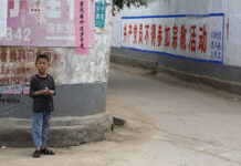 Car Strikes Children Outside China School, Kills 5 People A child stands in the street in June in China's Henan province. Photo: Ng Han Guan / Associated Press