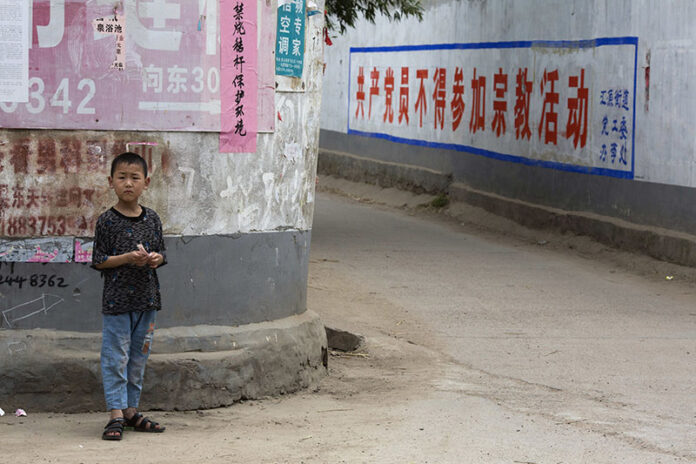 A child stands in the street in June in China's Henan province. Photo: Ng Han Guan / Associated Press
