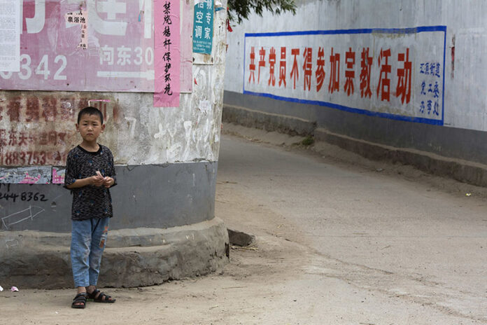 A child stands in the street in June in China's Henan province. Photo: Ng Han Guan / Associated Press A child stands in the street in June in China's Henan province. Photo: Ng Han Guan / Associated Press