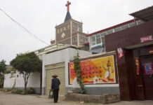 Woman With Knife Injures 14 Children at Western China School In this photo taken Saturday, June 2, 2018, a resident walks past a government billboard citing core values of the Communist Party near a church in the city of Pingdingshan in central China's Henan province. Photo: Ng Han Guan / Associated Press