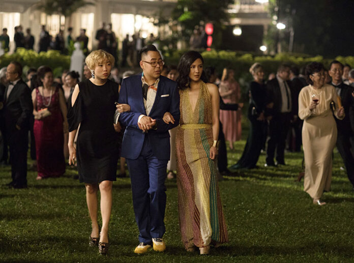 This image released by Warner Bros. Entertainment shows Awkwafina, from left, Nico Santos and Constance Wu in a scene from the film 