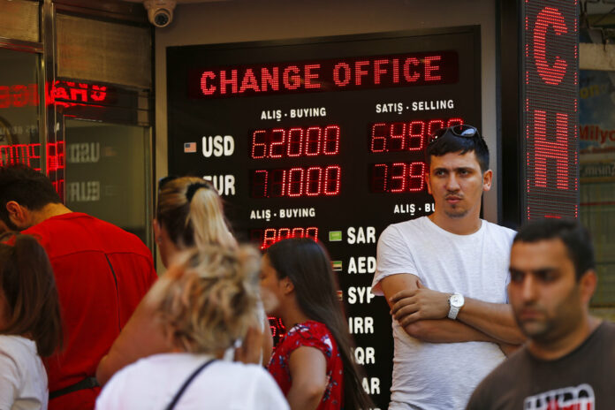 People line up at a currency exchange shop Aug. 14, 2018 in Istanbul. Photo: Lefteris Pitarakis / Associated Press People line up at a currency exchange shop Aug. 14, 2018 in Istanbul. Photo: Lefteris Pitarakis / Associated Press