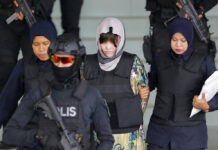Judge Finds Conspiracy to Kill Kim With VX, Women to Testify Vietnamese Doan Thi Huong, center, is escorted by police as she leaves her court hearing Thursday at the Shah Alam High Court in Shah Alam, Malaysia. Photo: Yam G-Jun / Associated Press