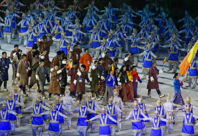 The Bhutan team marches into the Gelora Bung Karno Stadium Saturday during the opening ceremony for the 18th Asian Games , Jakarta, Indonesia. Photo: Firdia Lisnawati / Associated Press