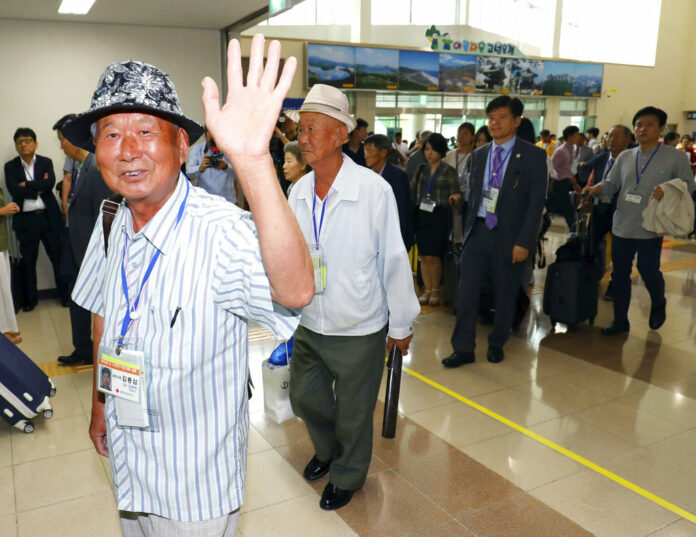 South Koreans leave for North Korea to take part in family reunions with their North Korean family members Monday at the customs, immigration and quarantine (CIQ) office, in Goseong, South Korea. Photo: Associated Press South Koreans leave for North Korea to take part in family reunions with their North Korean family members Monday at the customs, immigration and quarantine (CIQ) office, in Goseong, South Korea. Photo: Associated Press
