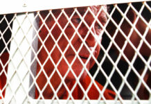 Cambodia Court Views Footage of Accused Australian Filmmaker Australian filmmaker James Ricketson sits in a police truck upon his arrival Monday at Phnom Penh Municipal Court in Phnom Penh, Cambodia. Photo: Heng Sinith / Associated Press
