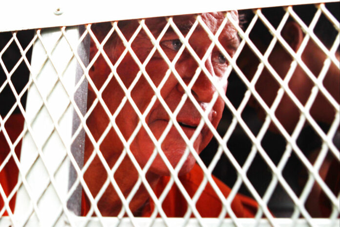 Australian filmmaker James Ricketson sits in a police truck upon his arrival Monday at Phnom Penh Municipal Court in Phnom Penh, Cambodia. Photo: Heng Sinith / Associated Press Australian filmmaker James Ricketson sits in a police truck upon his arrival Monday at Phnom Penh Municipal Court in Phnom Penh, Cambodia. Photo: Heng Sinith / Associated Press