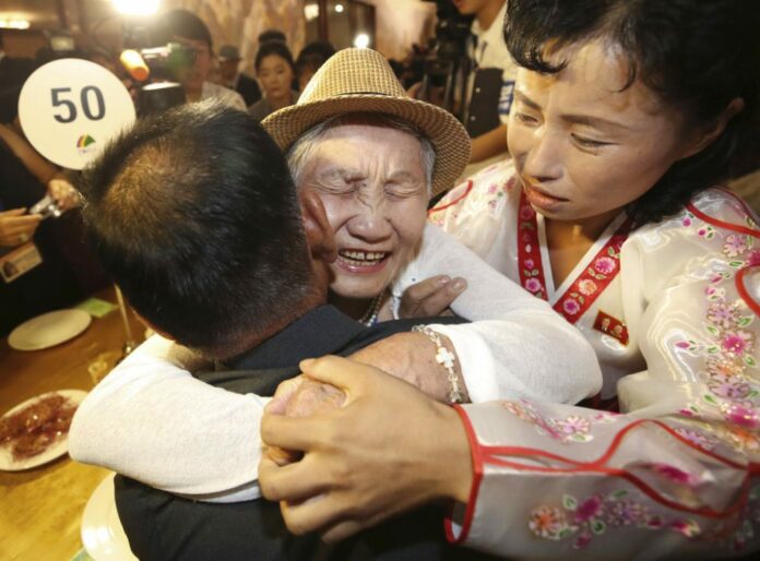 South Korean Lee Keum-seom, 92, on Monday hugs her North Korean son Ri Sang Chol, 71, left, with Kim Ok Hui, daughter-in-law of Ri Sang Chol during the Separated Family Reunion Meeting at the Diamond Mountain resort in North Korea. Photo: Lee Ji-eun / Yonhap via AP