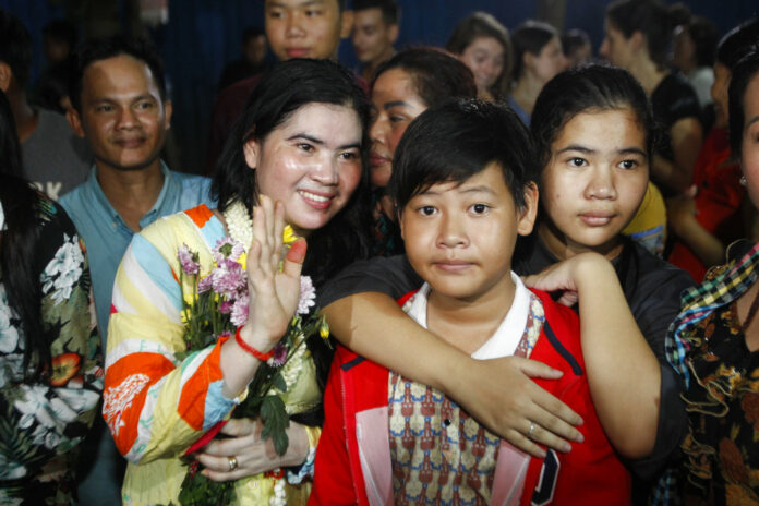 Tep Vanny, second from left, a prominent leader of Cambodia's land rights activist, gestures upon the arrival at her home Monday in Boeung Kak, in Phnom Penh, Cambodia. Photo: Heng Sinith / Associated Press