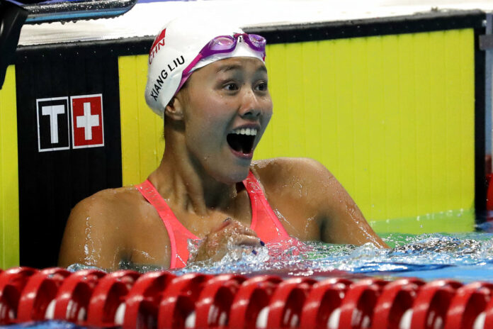 China's Liu Xiang celebrates after winning the women's 50m backstroke final during the swimming competition Tuesday at the 18th Asian Games in Jakarta, Indonesia. Photo: Lee Jin-man / Associated Press