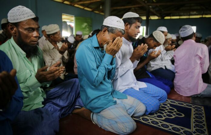 Rohingya refugees cry in August as they pray inside a mosque on Eid al Adha at Kutupalong refugee camp, Bangladesh. Photo: Altaf Qadri / Associated Press