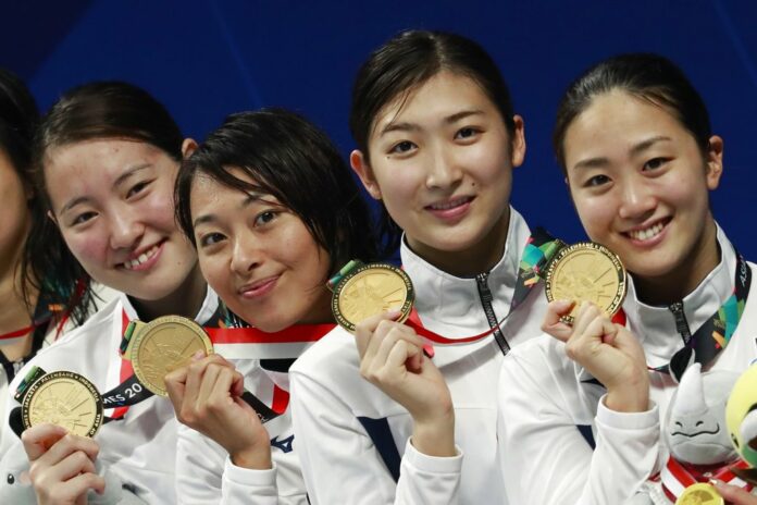 Japan's women's 4x100m medley relay team celebrate their gold medal during swimming competition at the 18th Asian Games on Thursday in Jakarta, Indonesia. Photo: Bernat Armangue / Associated Press