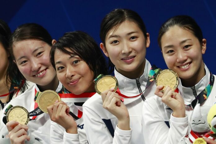 Japan's women's 4x100m medley relay team celebrate their gold medal during swimming competition at the 18th Asian Games on Thursday in Jakarta, Indonesia. Photo: Bernat Armangue / Associated Press Japan's women's 4x100m medley relay team celebrate their gold medal during swimming competition at the 18th Asian Games on Thursday in Jakarta, Indonesia. Photo: Bernat Armangue / Associated Press