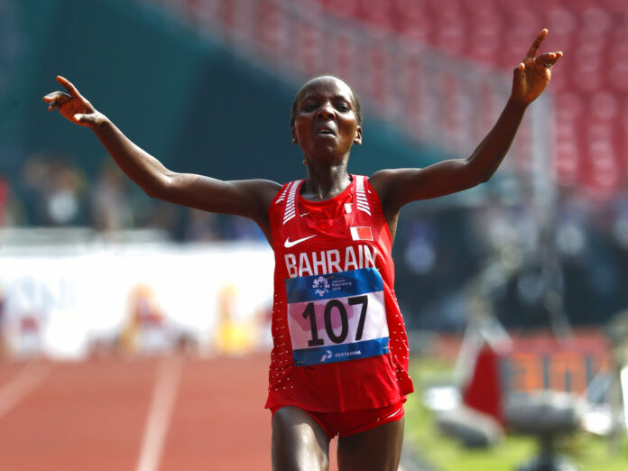 Bahrain's Rose Chelimo crosses the finish line Sunday to win the women's marathon during the athletics competition at the 18th Asian Games in Jakarta, Indonesia. Photo: Bernat Armangue / Associated Press
