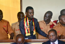 Uganda Opposition Pop Star Blocked From Flying to US for Aid Ugandan pop star-turned-lawmaker Kyagulanyi Ssentamu, also known as Bobi Wine, center, arrives at a magistrate's court Aug. 23 in Gulu, northern Uganda. Photo: Associated Press