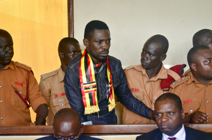 Ugandan pop star-turned-lawmaker Kyagulanyi Ssentamu, also known as Bobi Wine, center, arrives at a magistrate's court Aug. 23 in Gulu, northern Uganda. Photo: Associated Press