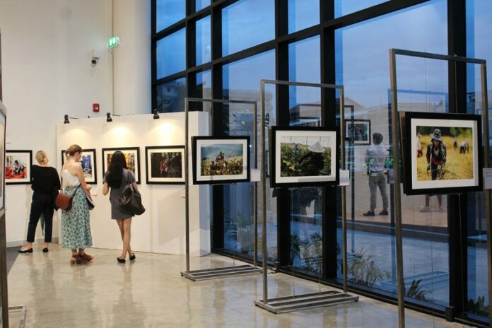 Attendees view photographs at UN Women’s opening exhibition of ‘Migrant Workers in Southeast Asia’ on Thursday at Alliance Francaise in Bangkok. Photos: Taylor McAvoy