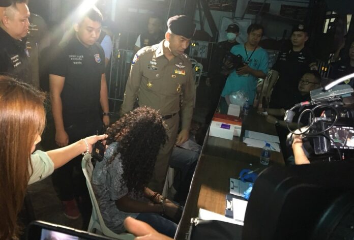 Tourist Police chief Maj. Gen. Surachet Hakpal, standing at center, at a Friday press briefing on Khaosan Road.