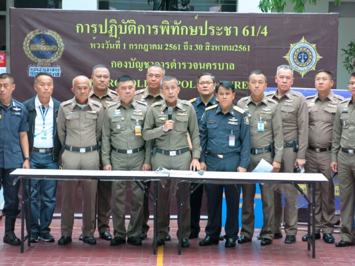 Police line up for a photo-op to take credit for drug arrests and seizures in a two month period in Bangkok.