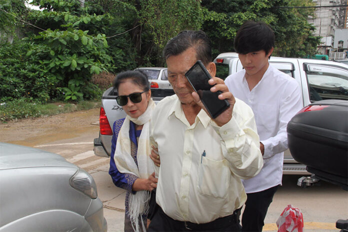 Jiratpisit Jaravijit, at right, with his father Suwit Jaravijit and mother Lertchatkamol Jaravijit on Monday at the Crime Suppression Division in Bangkok.