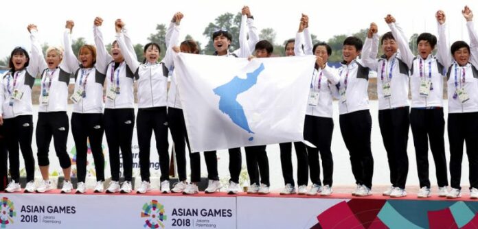 Members of combined Koreas team celebrate their victory during the ceremony for women's 500-meter dragon boat Sunday at the 18th Asian Games in Palembang, Indonesia. Photo: Kim Do-hun / Yonhap via AP