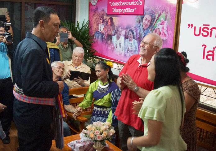 Gen. Anantaporn Kanchanarat, minister of Social Development and Human Security, left, greets Farang and Thai attendees at the opening of the Thai Daughter-in-Law, Farang Son-in-Law Clinic Wednesday in Khon Kaen.