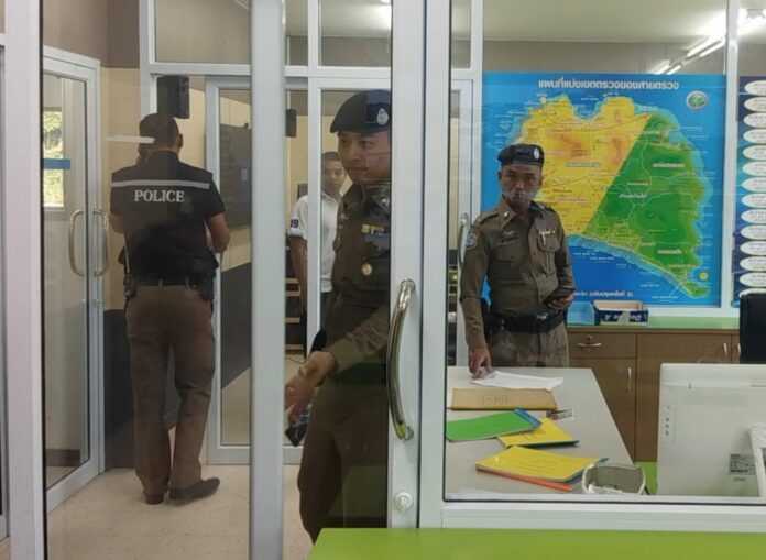 Police officers hold a meeting Sunday on Koh Phangan.