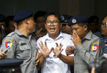 Myanmar Court Sentences Reuters Reporters to 7 Years in Jail Reuters journalist Wa Lone, center, talks to journalists as he is escorted by police to leave a court in Yangon, Myanmar Monday, Sept. 3, 2018. Photo: Thein Zaw / Associated Press