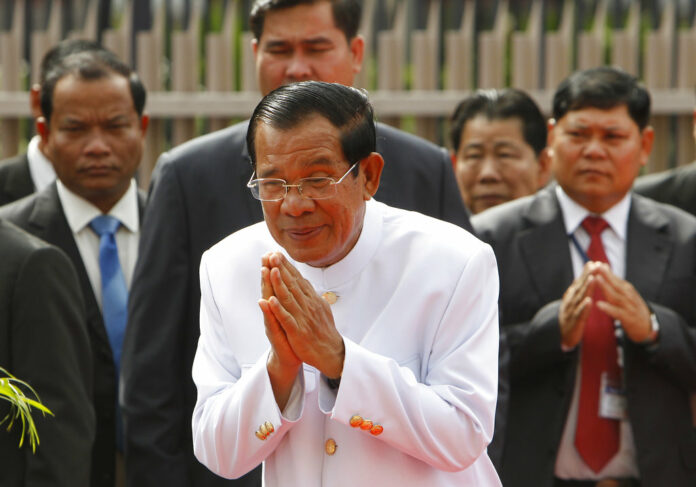 Cambodia's Prime Minister Hun Sen, center, sees King Norodom Sihamoni off in September in front of the National Assembly in Phnom Penh, Cambodia. Photo: Heng Sinith / Associated Press