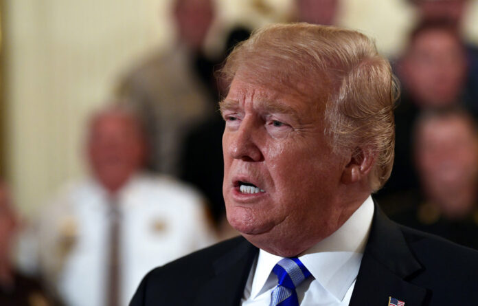 President Donald Trump responds to a reporters question Wednesday during an event with sheriffs in the East Room of the White House in Washington. Photo: Susan Walsh / Associated Press