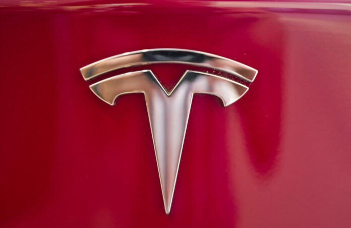 This Aug. 8, 2018, file photo shows a Tesla emblem on the back end of a Model S in the Tesla showroom in Santa Monica, California. Photo: Richard Vogel / Associated Press This Aug. 8, 2018, file photo shows a Tesla emblem on the back end of a Model S in the Tesla showroom in Santa Monica, California. Photo: Richard Vogel / Associated Press