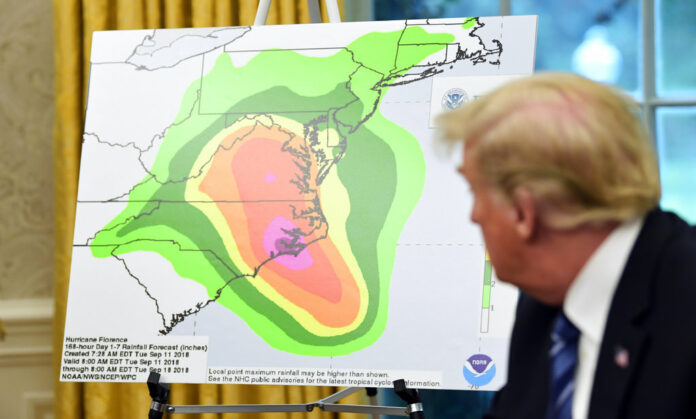 President Donald Trump looks at a chart showing potential rainfall totals from Hurricane Florence on Tuesday during a briefing in the Oval Office of the White House in Washington. Photo: Susan Walsh / Associated Press